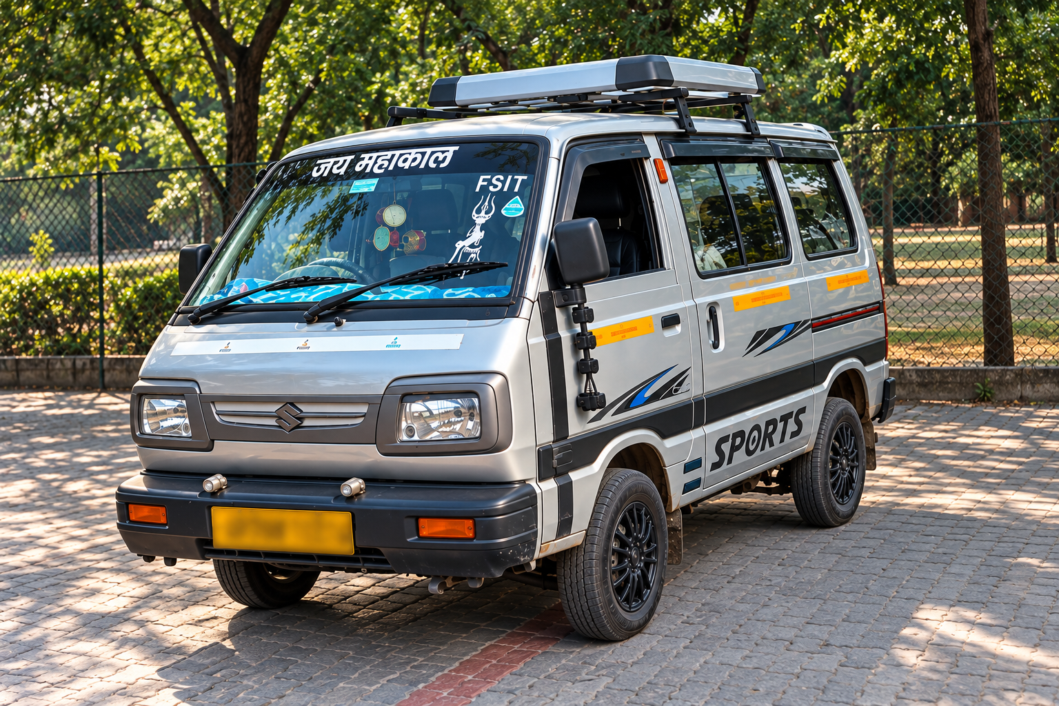White student transport van parked beside a leafy campus